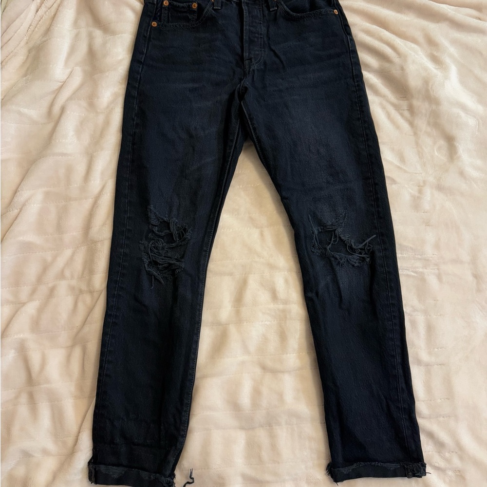 Women’s Ripped Black Levi's 501 jeans.